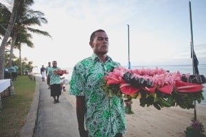 Outrigger on the Lagoon. Fiji staff with commemoration wreath.
