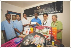 Anoop Naidu receives the donation from the Outrigger Staff