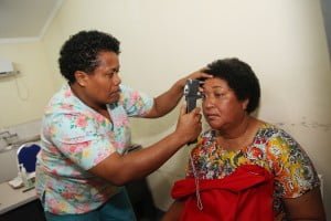 Nurse Maria checks a patients eye at the Sigatoka Hospital