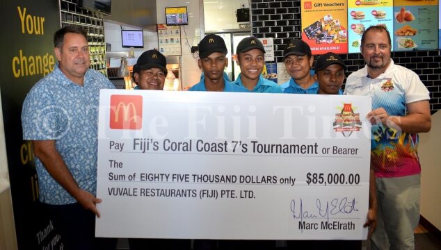 McDonalds Fiji Managing Director Marc McElrath (left) with McDonalds Nadi staff along with Coral Coast 7s tournament Director Jay Whyte during the presentation in Nadi yesterday. Picture: BALJEET SINGH