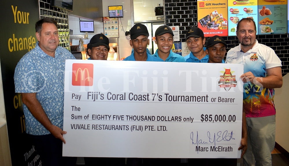 McDonalds Fiji Managing Director Marc McElrath (left) with McDonalds Nadi staff along with Coral Coast 7s tournament Director Jay Whyte during the presentation in Nadi yesterday. Picture: BALJEET SINGH